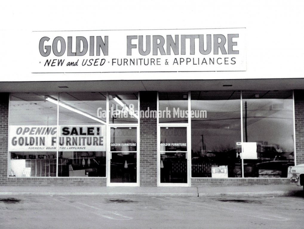 Goldin Furniture and Appliance store - Front of store with "Opening Sale" sign in window