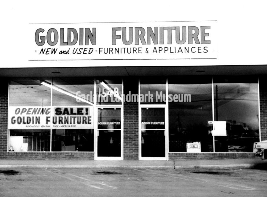 Goldin Furniture and Appliance store - Front of store with "Opening Sale" sign in window