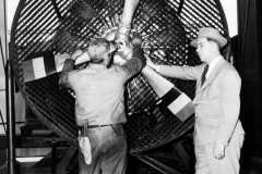 Allen Guiberson, right, stands beside a test model of the 9-cylinder radial Diesel engine