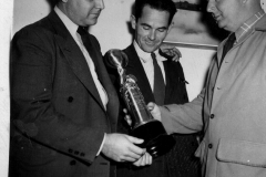 Tom Overstreet  (center) with 2 other men looking at trophy 1940's