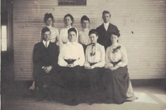 The teaching staff in 1904 was comprised of eight teachers. They were, front row, reading left to right, Vester McDonald, Miss Mabel Swim, Miss Basham, Miss Julia  Bethel  of Dallas, formerly of Garland; Miss Webb, elocution teacher, Miss Dora Harris, music teacher, and J.H. Burnett, superintendent.