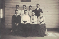 The teaching staff in 1904 was comprised of eight teachers. They were, front row, reading left to right, Vester McDonald, Miss Mabel Swim, Miss Basham, Miss Julia  Bethel  of Dallas, formerly of Garland; Miss Webb, elocution teacher, Miss Dora Harris, music teacher, and J.H. Burnett, superintendent.