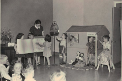 Pattie Harris and Bill Holmes holding book, Martha Harris reading, and Lyle Tucker on the horse at the Educational Exhibit State Fair of TX.