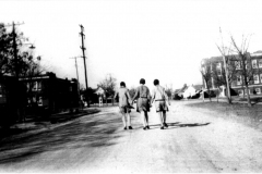 Three ladies walking north on9th St. at Ave. B; 1st Methodist Church on right and Garland Elementary School on left