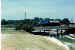 Duck Creek iron railroad bridge with train engine.