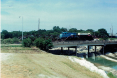Duck Creek iron railroad bridge with train engine.