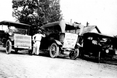 Cars with signs advertising "Garland Dollar Day"