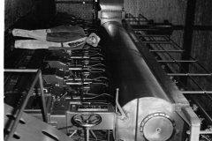 Charles E. Newman, who headed Garland Power and Light from 1923 to 1963, stands beside the new Nordberg generating unit installed in 1955 as the last expansion of the old dieselplant on Avenue A.