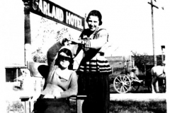 Lola Morrison Tawwater Wagoner standing in front of Garland Hotel, 5th & State Streets, ca. 1920