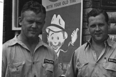 Howard Shugart, Bill Marshall with cartoon advertising sign - Shugart's Service Station