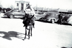 Dave Murphee, Deputy Tax Collector sitting on a donkey with a sign that says " I Ain't Got No Horse"; Poll Tax Drive ca 1940