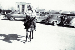 Dave Murphee, Deputy Tax Collector sitting on a donkey with a sign that says " I Ain't Got No Horse"; Poll Tax Drive ca 1940