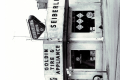 Front of Goldin Tire & Appliance Store, car at right side of building