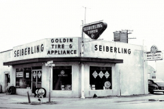 Front of Goldin Tire & Appliance Store, car at right side of building