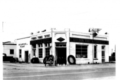 Goldin Tire & Supply store front with tires in front, car parked on left side of building