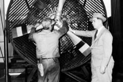 Allen Guiberson, right, stands beside a test model of the 9-cylinder radial Diesel engine