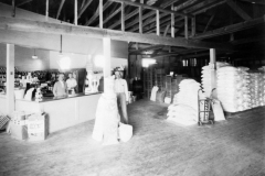 Interior of Roach Feed and Grocer Co., Haskell Lafayette Roach on the left