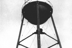 First water tower on the site by the first city well J.L. Ford Food Store, East side of square