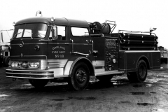 Garland Fire Department Truck No. 18 (GFD designation E-418).  1966 Mack C85, 1000 Gallons per minute, 500 gal).  Location of the fire truck is the Mack factory (Ref. L2015.02.E - Photograph of Firefighter at the control panel)