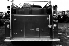 Garland Fire Department Truck No. 18 (GFD designation E-418).  1966 Mack C85, 1000 Gallons per minute, 500 gal).  Location of the fire truck is the Mack factory (Ref. L2015.02.E - Photograph of Firefighter at the control panel)