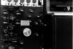 Control panel on Garland Fire Department Truck No. 18 (GFD designation E-418).  1966 Mack C85, 1000 Gallons per minute, 500 gal).  Location of the fire truck is at the Mack factory (Ref. L2015.02.E - Photograph of Firefighter at the control panel)
