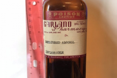 Bottle from Garland Pharmacy containing denatured alcohol.