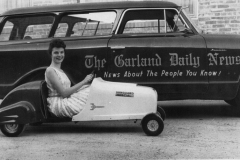 1960-1961 Carolee Beaty driving the Vanguard Special beside the Garland Daily News van.