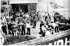 Photo of crowd examining tractor with winch and tread.