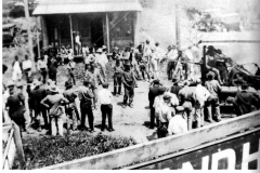 Photo of crowd examining tractor with winch and tread.
