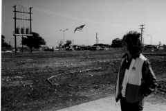 Woman in Texas flag jacket at Garland Heliport, Jupiter Road and Grader St