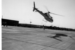 Aerospatiale helicopter  in midair - Garland Heliport, Jupiter Road and Grader St Band at opening ceremony - Garland Heliport, Jupiter Road and Grader St  Dignitaries and band at opening ceremony - Garland Heliport Opening ceremony at Garland Heliport, Jupiter Road and Grader St