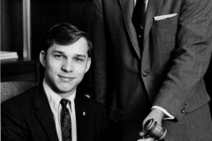 Elbert Kennemer, Councilman, standing, handing gavel to a young man 1960's