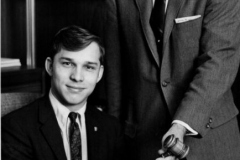 Elbert Kennemer, Councilman, standing, handing gavel to a young man 1960's