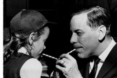 Father Monsignor Smid, girl and man drinking Coca-Cola