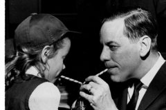 Father Monsignor Smid, girl and man drinking Coca-Cola