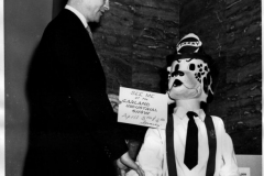 Publicity chairman Louis Howard greets "Sparky the Fire Dog"