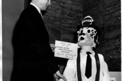 Publicity chairman Louis Howard greets "Sparky the Fire Dog"