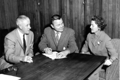 Left to right, Robert McCullough, Ernie Wright, Mayor of Garland, and Mrs. J. W. Nicholson, likely checking plans for the "Mothers' March of Mercy" drive.