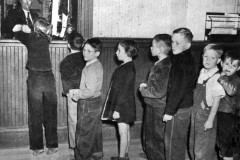 Children buying their train tickets.