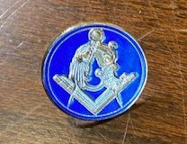 Masonic pin of gold tone metal, with gold Masonic symbol in blue background