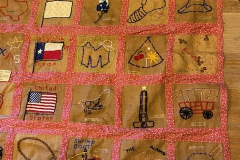 Quilt showing Texas icons and flags with designs by Janie Suter's class