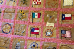 Quilt showing Texas icons and flags with designs by Janie Suter's class