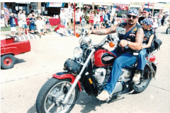 A man and a young boy on a Shadow motorcycle in the Star Spangled Fourth parade 1998