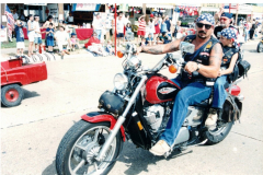 A man and a young boy on a Shadow motorcycle in the Star Spangled Fourth parade 1998