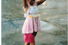 Young girl dancing in the rain during Star Spangled Fourth 1998