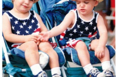 Two little boys wearing patriotic colors in stroller - Star Spangled Fourth 1998