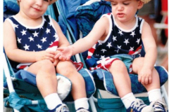 Two little boys wearing patriotic colors in stroller - Star Spangled Fourth 1998