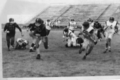 Football players at Williams Stadium circa 1970. #30 with the football is Eddie Horstman.