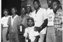 Members of Carver High School and their manager with two baseball trophies