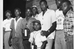 Members of Carver High School and their manager with two baseball trophies